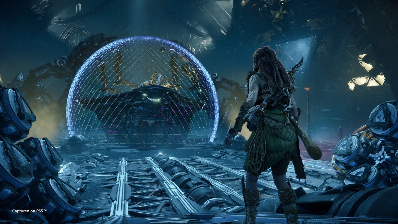 Aloy facing an energy shielded robotic foe in a derelict facility in Horizon Forbidden West