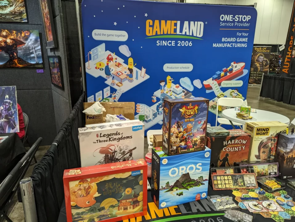 GameLand's booth full of boxed board games at Origins Game Fair 2024.